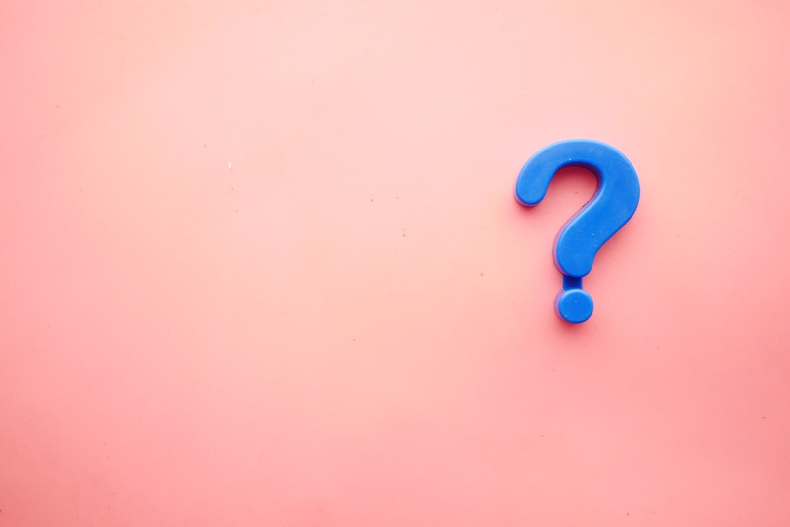 a blue question mark on a pink background - frequently asked questions about kona coffee